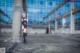 A woman with pink hair standing in front of a building.