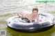 A woman in a bikini is floating on an inflatable tube.